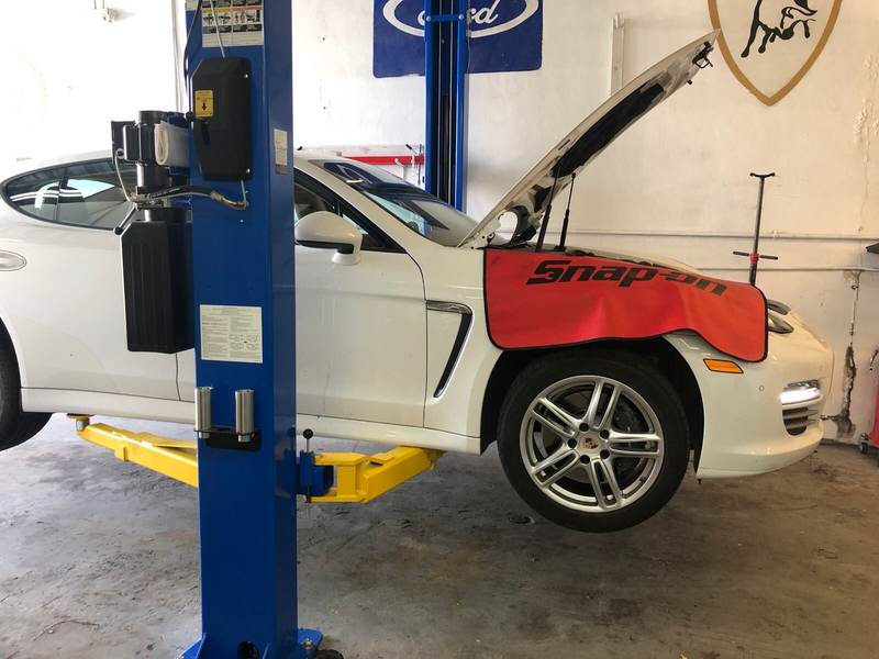 Porsche Panamera on a lift for mechanical repair at PorscheWorks, Gold Coast Collision Center
